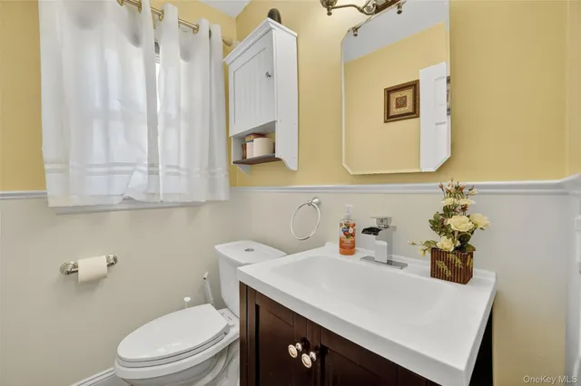a bathroom with a sink a toilet and vanity