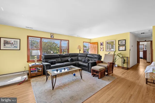 a living room with furniture or couch and a wooden floor