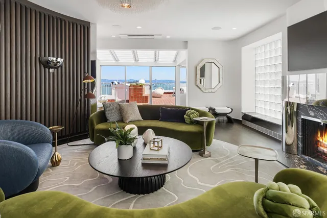 a living room with furniture a fireplace and a flat screen tv