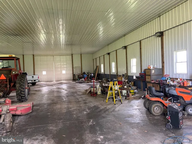 a view of a grassy field with trees in the background