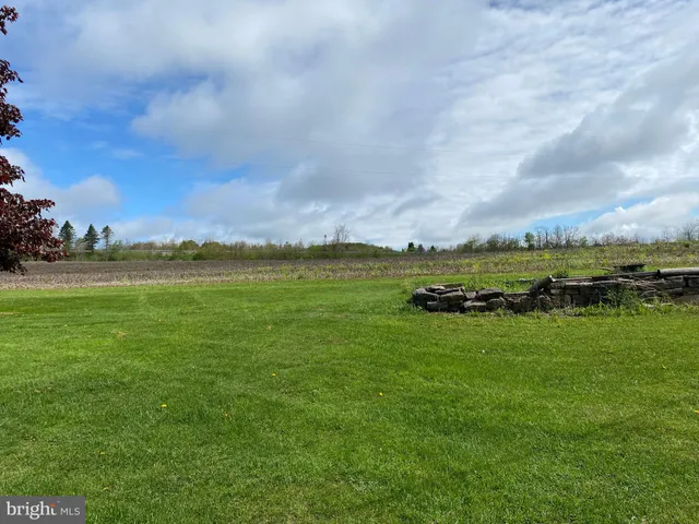 a view of a house with pool and a yard