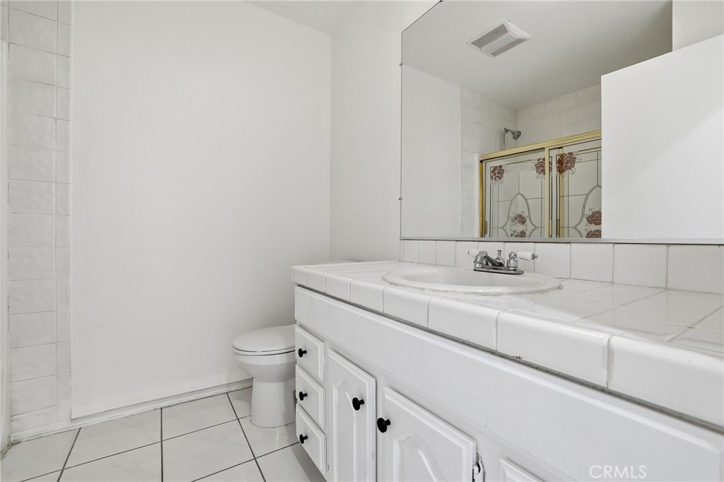 12755 Judd Street Pacoima, CA 91331 - Photo 15 of 46 a bathroom with a sink a toilet and a mirror