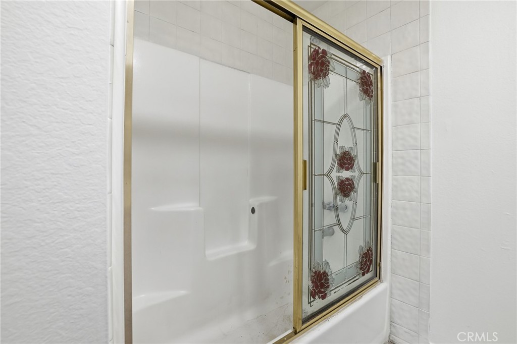 12755 Judd Street Pacoima, CA 91331 - Photo 16 of 46 a bathroom with a glass shower door