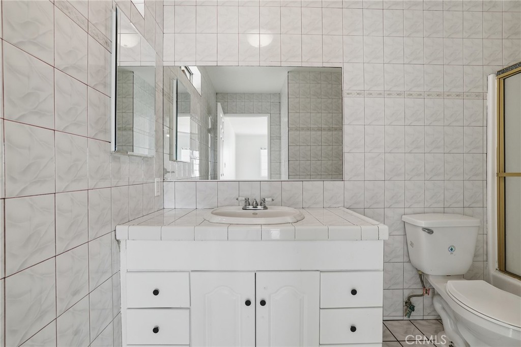 12755 Judd Street Pacoima, CA 91331 - Photo 26 of 46 a bathroom with a sink and a mirror