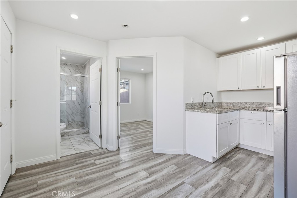 12755 Judd Street Pacoima, CA 91331 - Photo 32 of 46 a kitchen with granite countertop white cabinets and stainless steel appliances