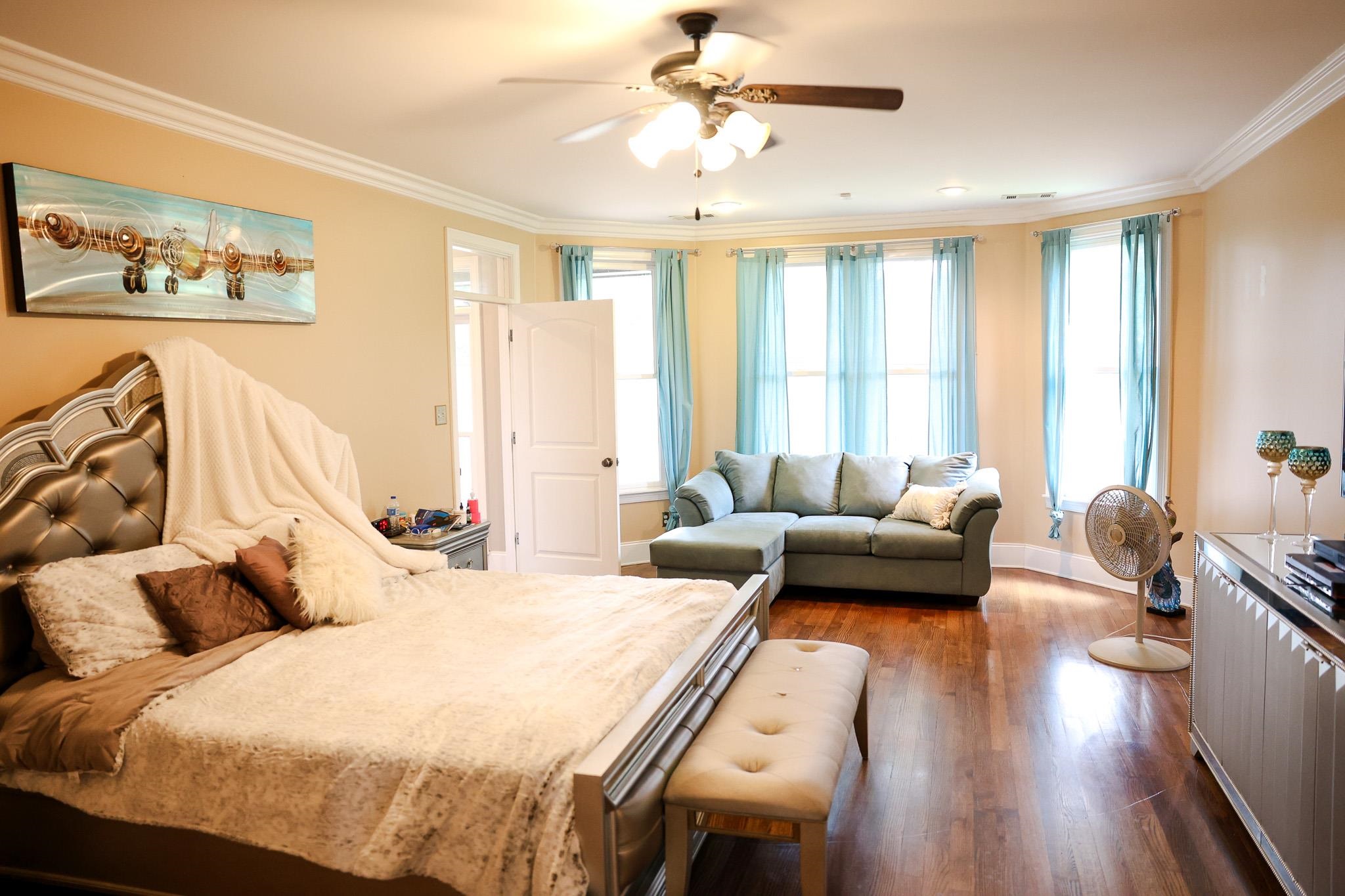 649 Ridge Springs Road Collierville, TN 38017 - Photo 20 of 35 Bedroom with crown molding, multiple windows, dark wood-type flooring, and a ceiling fan