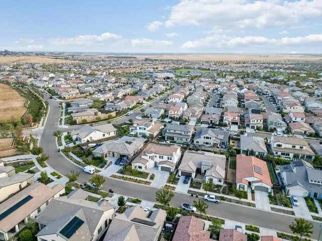 a view of a swimming pool and a yard with palm trees