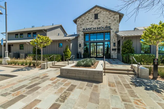a front view of a building with a garden