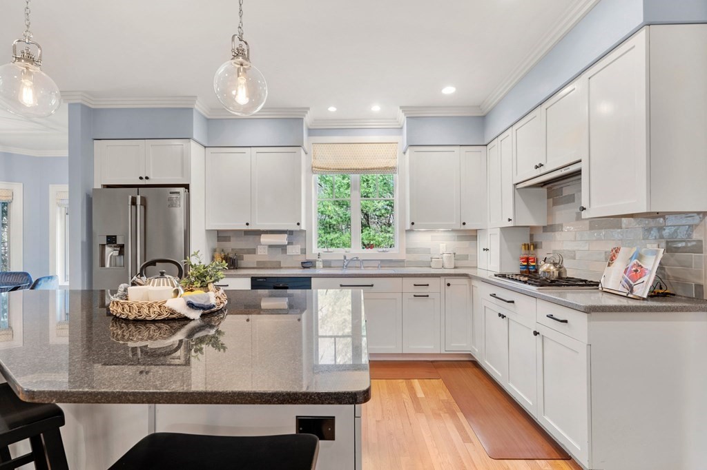 11 Wenham Road Newton, MA 02461 - Photo 2 of 19 a kitchen with kitchen island granite countertop a white cabinets and window