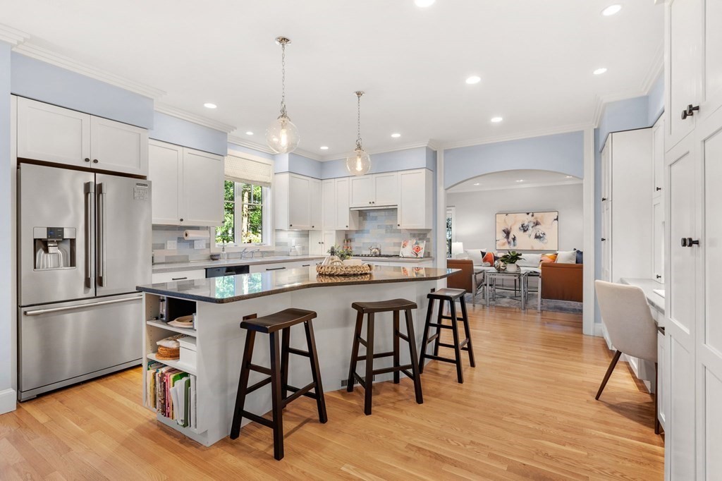 11 Wenham Road Newton, MA 02461 - Photo 3 of 19 a kitchen with stainless steel appliances a dining table chairs stove refrigerator and cabinets