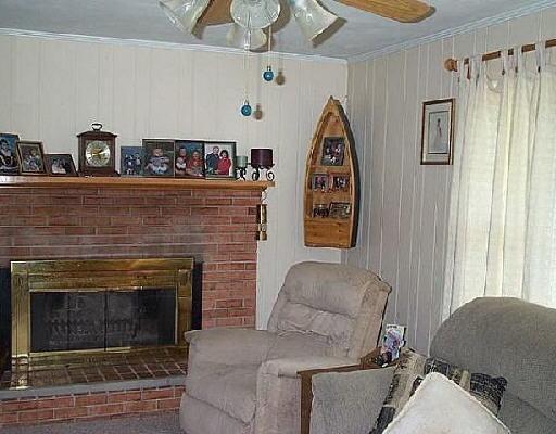 2117 Byrd Road Elliston, VA 24087 - Photo 2 of 6 a living room with furniture a fireplace and a window