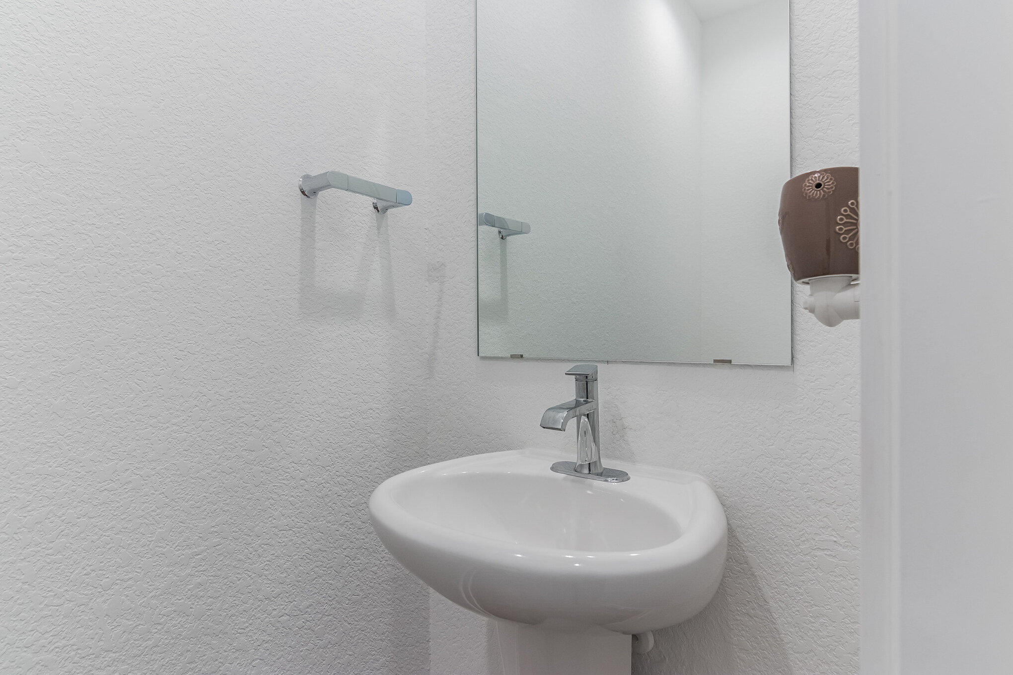 116 Century Plant Road Leander, TX 78641 - Photo 17 of 30 A minimalist pedestal sink anchors this clean powder room.