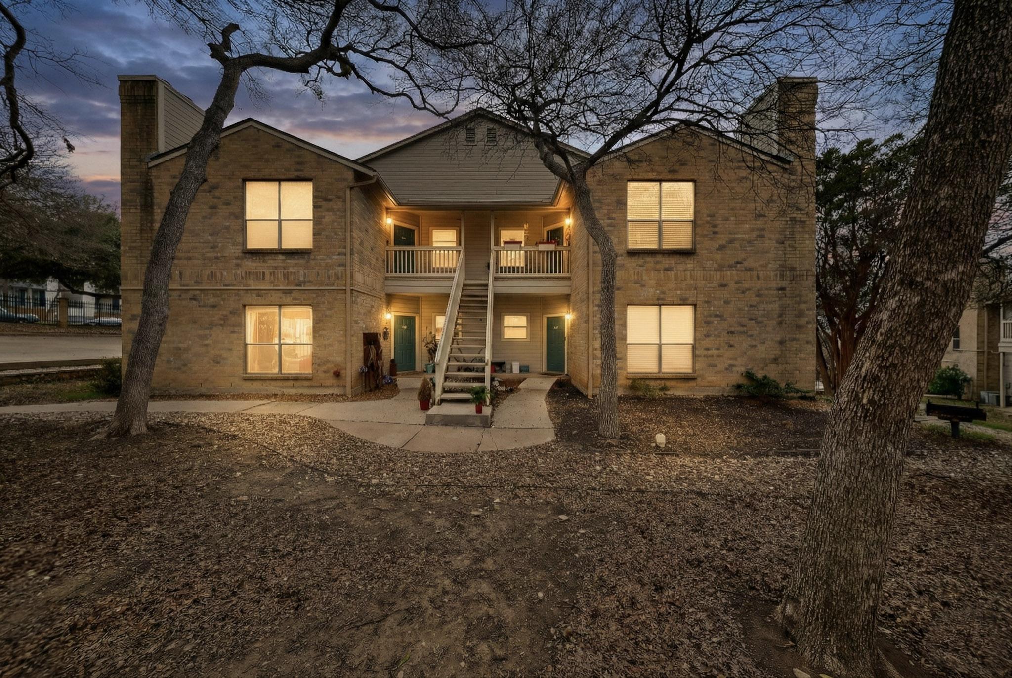 2450 Wickersham Lane, Unit 904 Austin, TX 78741 - Photo 1 of 1 Rear view of property with a chimney, brick siding, and covered porch