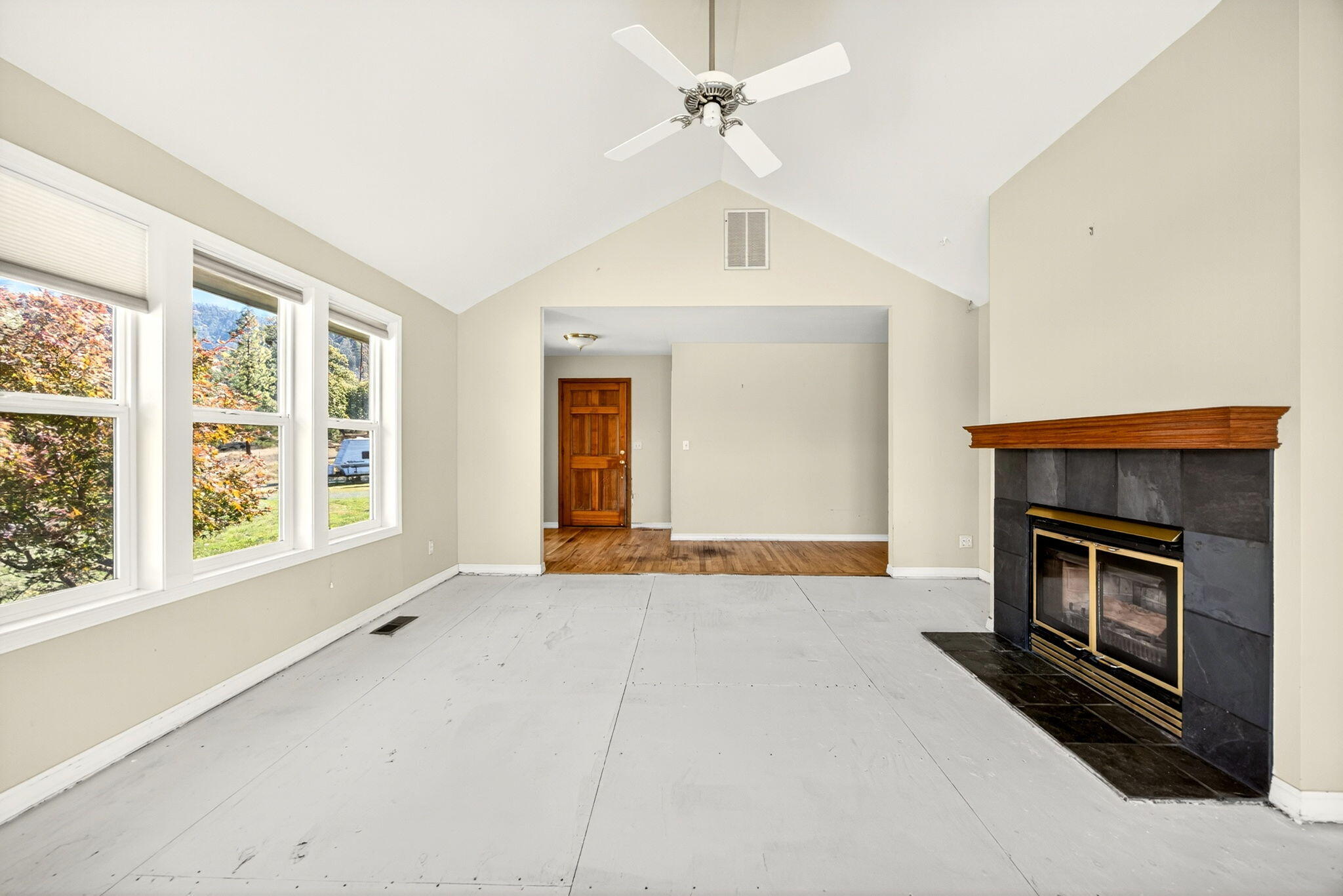 2467 Eastside Road Jacksonville, OR 97530 - Photo 52 of 85 an empty room with windows and fireplace