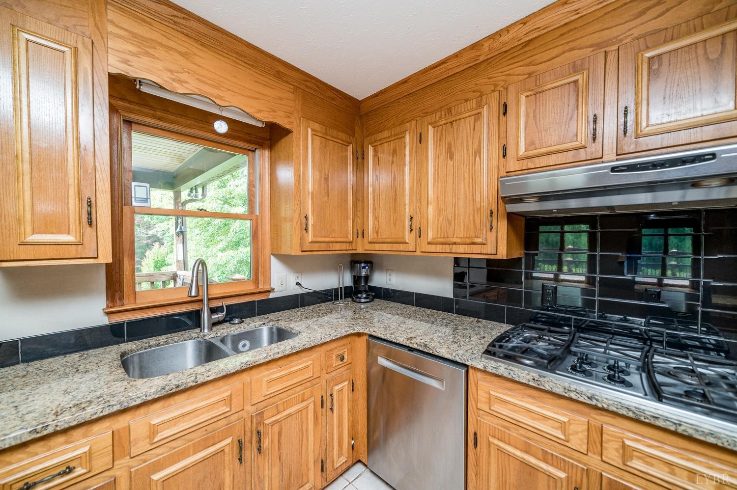 1796 Union Church Road Thaxton, VA 24174 - Photo 38 of 83 a kitchen with granite countertop a sink and a window