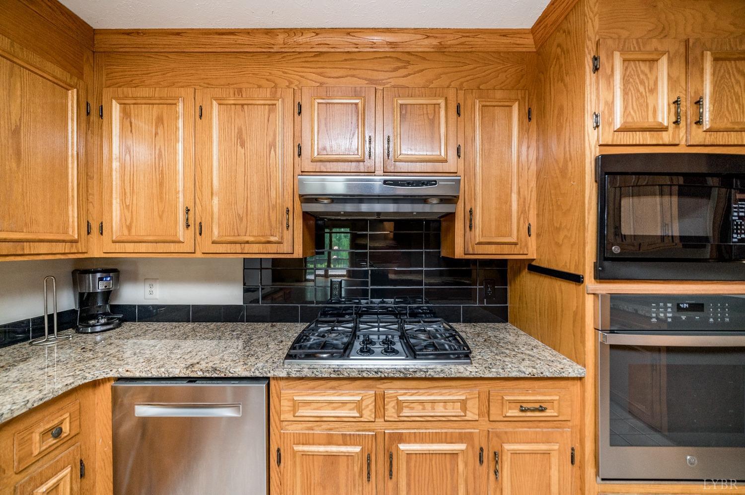 1796 Union Church Road Thaxton, VA 24174 - Photo 39 of 83 a kitchen with granite countertop a stove and a sink