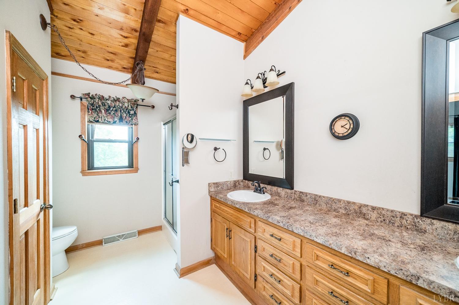 1796 Union Church Road Thaxton, VA 24174 - Photo 49 of 83 a spacious bathroom with a granite countertop sink and a mirror