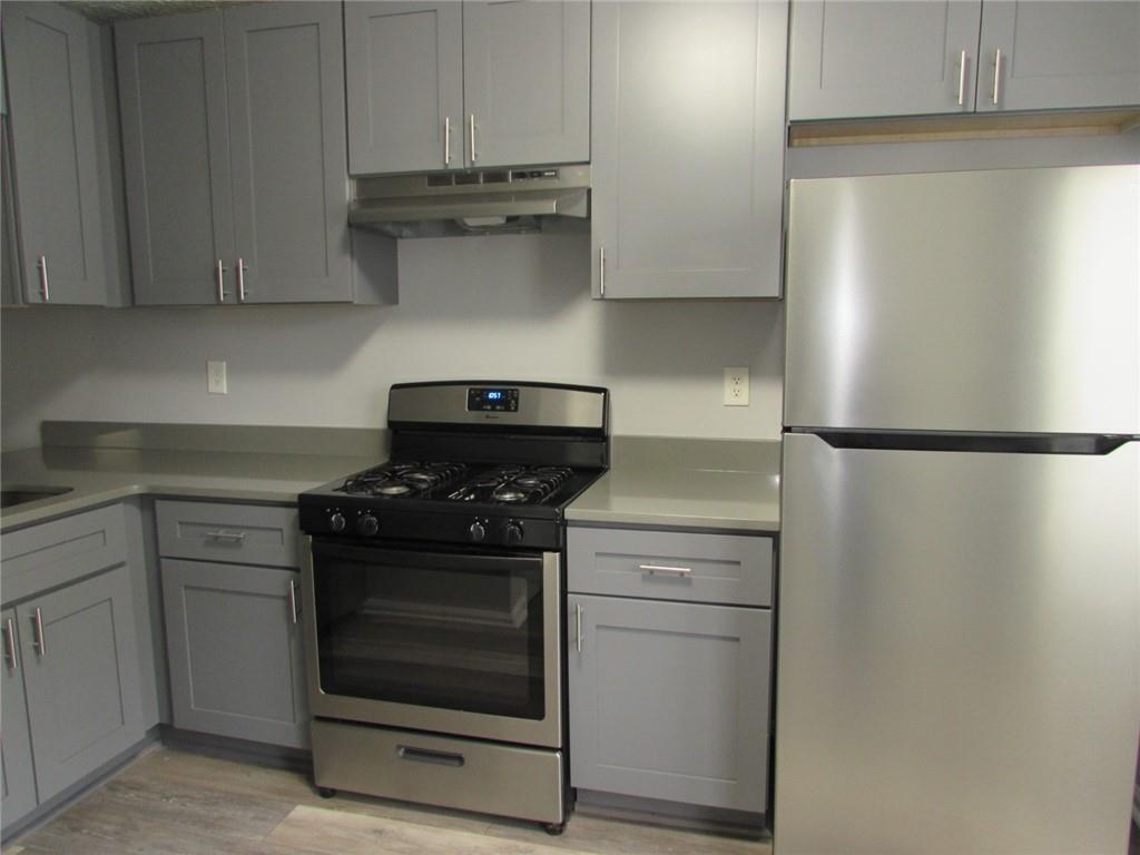 835 Heritage Valley Road Norcross, GA 30093 - Photo 34 of 34 a kitchen with stainless steel appliances granite countertop a stove and a refrigerator