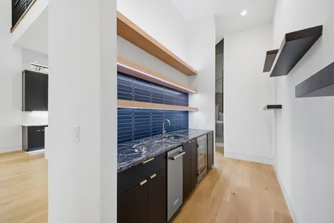a view of a hallway with wooden shelves