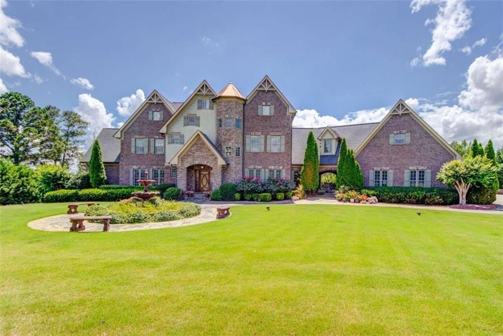 a front view of house with yard and green space