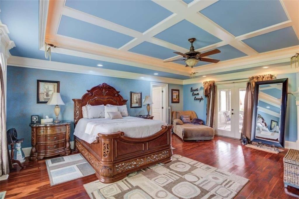 2008 Costley Mill Road Northeast Conyers, GA 30013 - Photo 15 of 55 a bedroom with a large bed and a chandelier