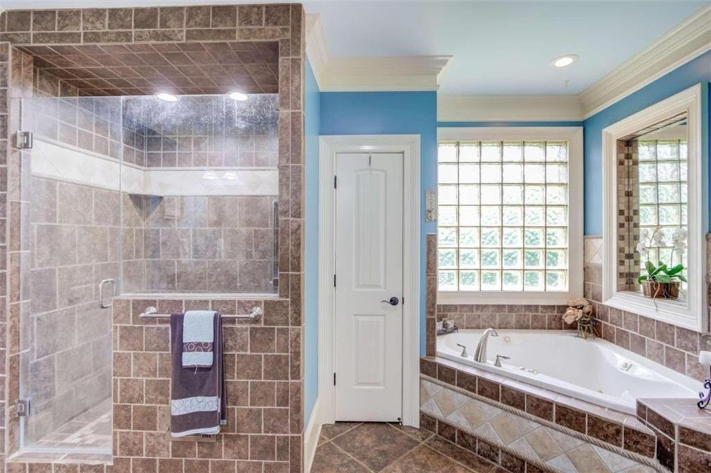 2008 Costley Mill Road Northeast Conyers, GA 30013 - Photo 17 of 55 a spacious bathroom with a tub shower and a sink