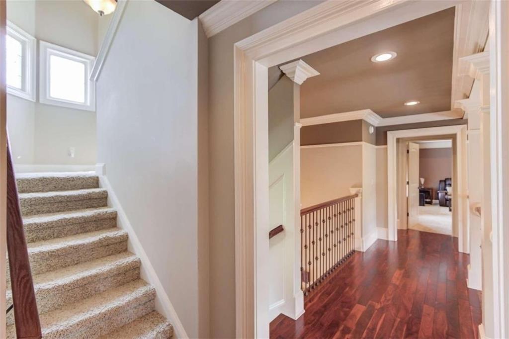 2008 Costley Mill Road Northeast Conyers, GA 30013 - Photo 25 of 55 a view of a hallway with wooden floor and staircase