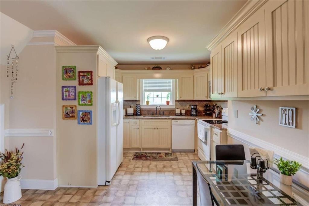 2008 Costley Mill Road Northeast Conyers, GA 30013 - Photo 37 of 55 a kitchen with stainless steel appliances granite countertop a refrigerator and a stove top oven