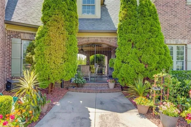 a view of a house with backyard and sitting area