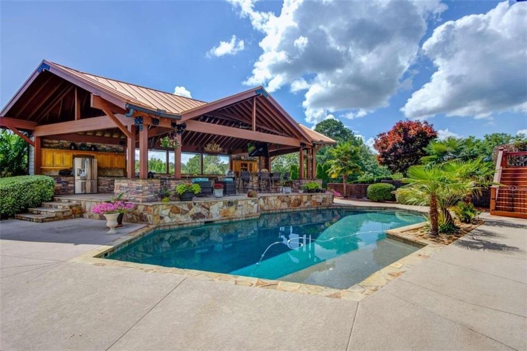 2008 Costley Mill Road Northeast Conyers, GA 30013 - Photo 50 of 55 a view of a house with sitting area and garden