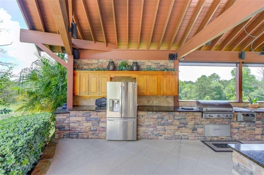 2008 Costley Mill Road Northeast Conyers, GA 30013 - Photo 53 of 55 a view of a patio with table and chairs under an umbrella