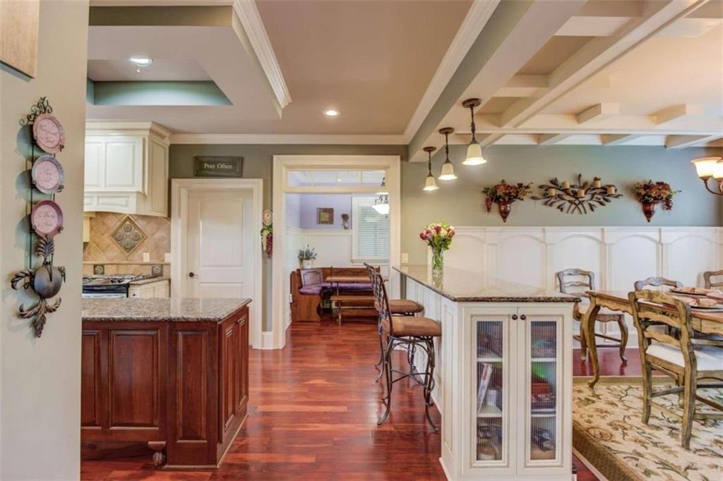 2008 Costley Mill Road Northeast Conyers, GA 30013 - Photo 9 of 55 a kitchen with stainless steel appliances kitchen island granite countertop a table and chairs in it