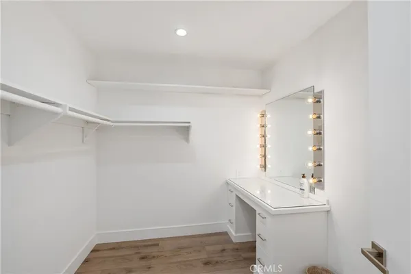 a bathroom with a sink a toilet a mirror and shower