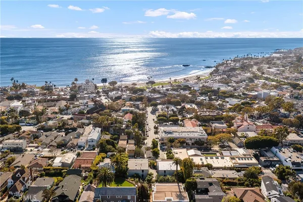 an aerial view of a building with beach and ocean view