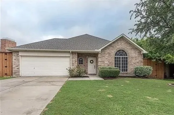 a front view of a house with a garden and yard