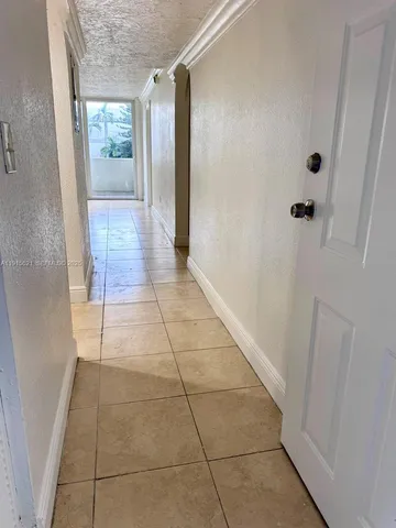 a hallway with sliding door and main door