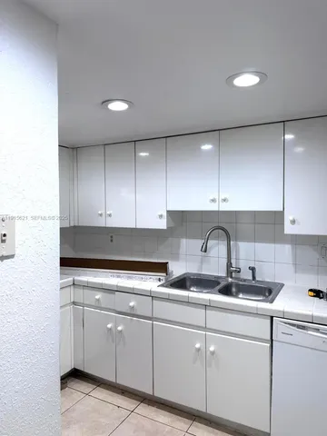 a kitchen with cabinets appliances and a sink
