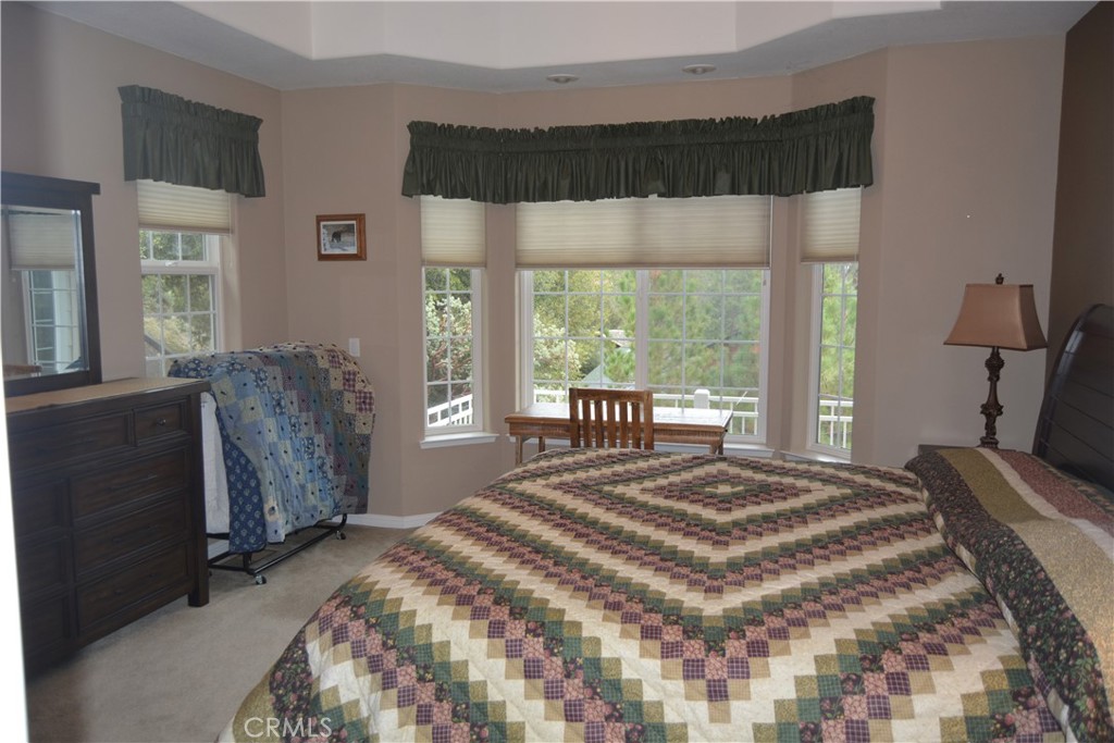 39818 Granite Ridge Lane Bass Lake, CA 93604 - Photo 11 of 29 a bedroom with a large bed and a large window