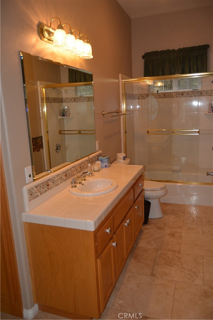 39818 Granite Ridge Lane Bass Lake, CA 93604 - Photo 12 of 29 a bathroom with a sink a toilet and shower