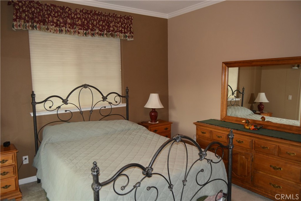 39818 Granite Ridge Lane Bass Lake, CA 93604 - Photo 13 of 29 a bedroom with a bed and a dresser with mirror