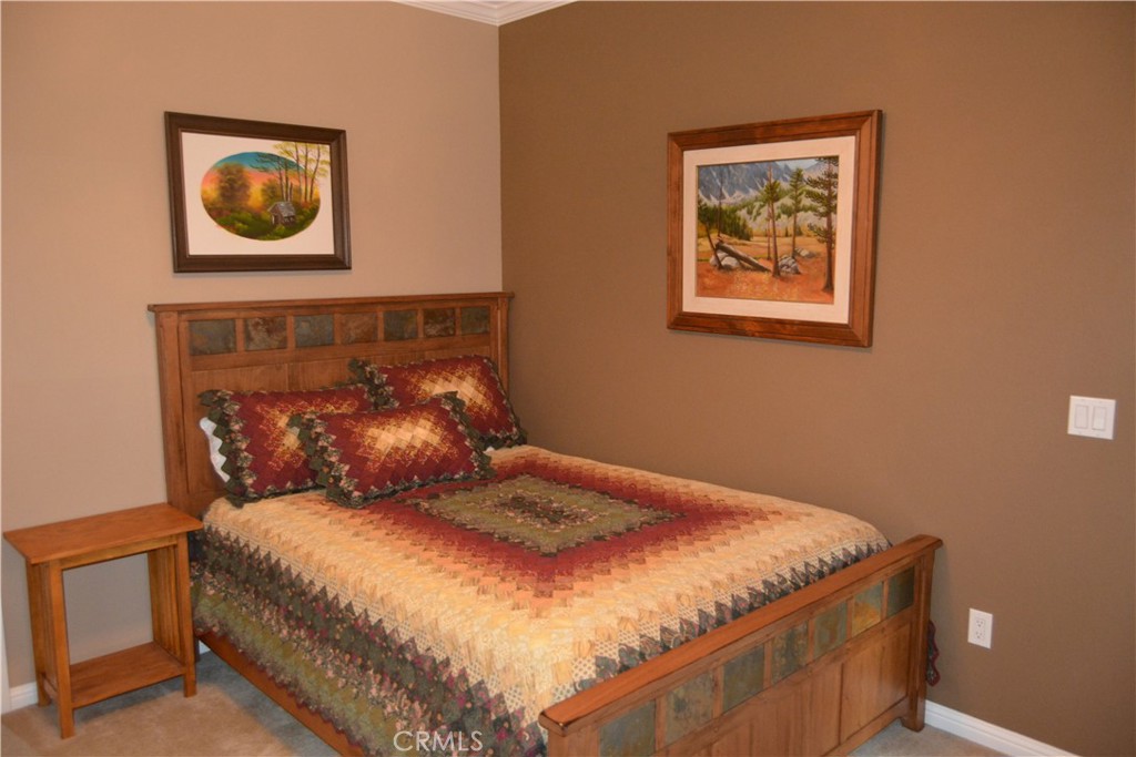 39818 Granite Ridge Lane Bass Lake, CA 93604 - Photo 17 of 29 a bed sitting in a bedroom next to a wall