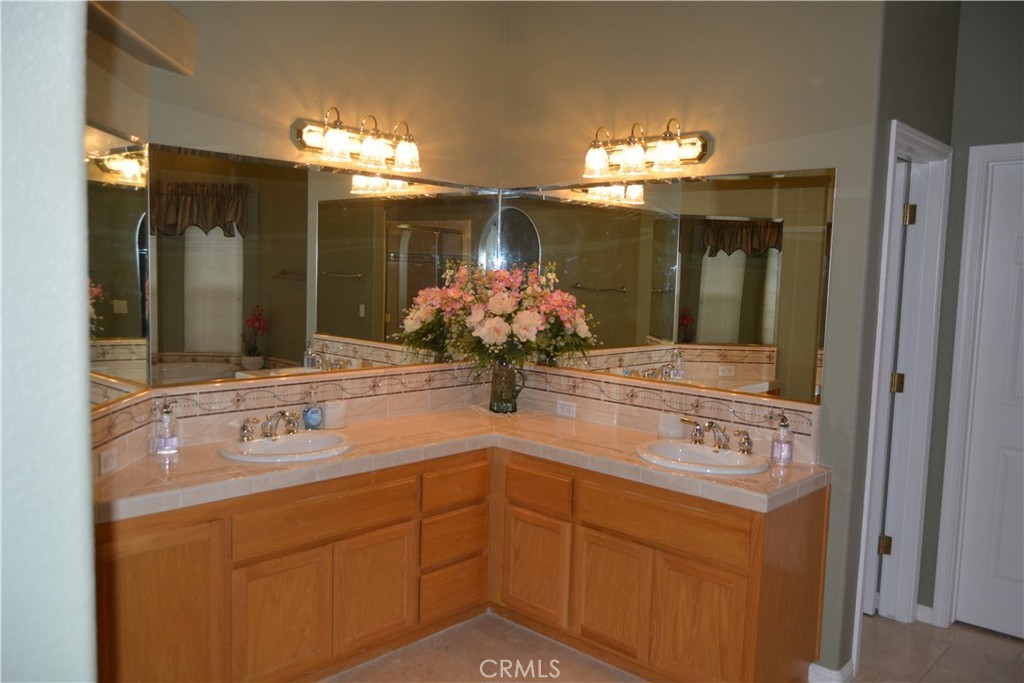 39818 Granite Ridge Lane Bass Lake, CA 93604 - Photo 19 of 29 a bathroom with a sink double vanity and a mirror