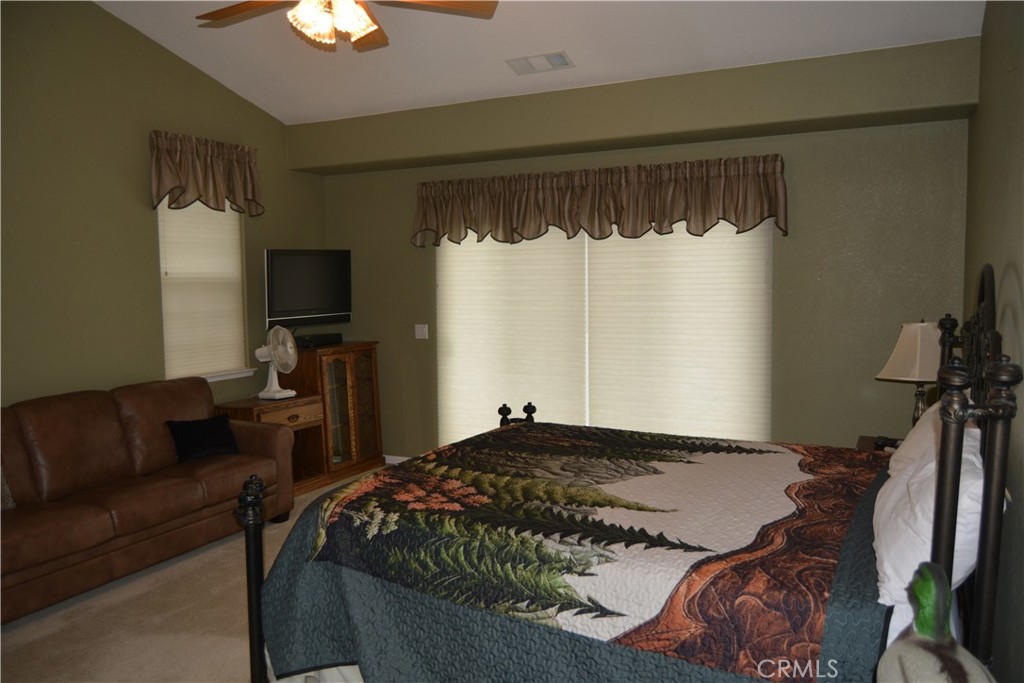 39818 Granite Ridge Lane Bass Lake, CA 93604 - Photo 21 of 29 a bedroom with a bed window and a flat screen tv