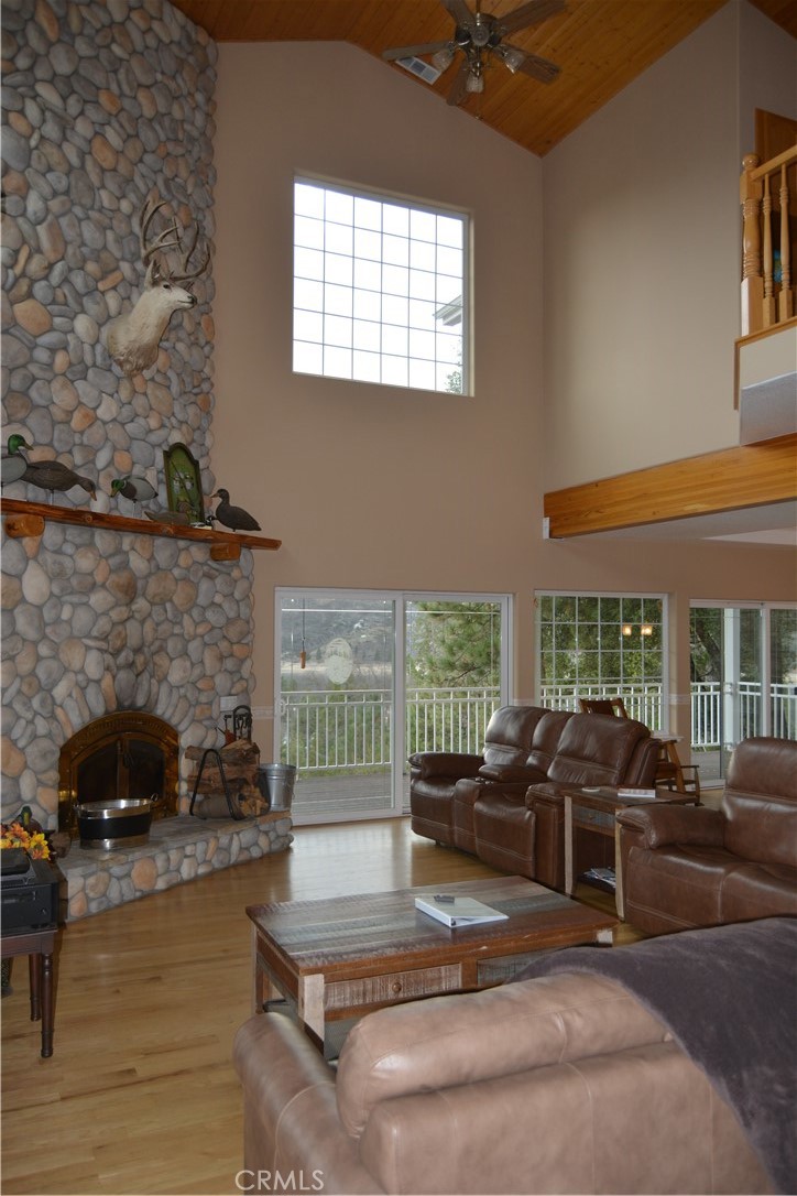39818 Granite Ridge Lane Bass Lake, CA 93604 - Photo 22 of 29 a living room with furniture and a fireplace