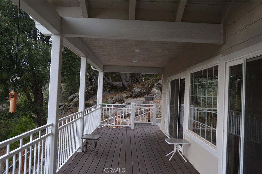 39818 Granite Ridge Lane Bass Lake, CA 93604 - Photo 24 of 29 a view of a balcony with chairs and wooden floor