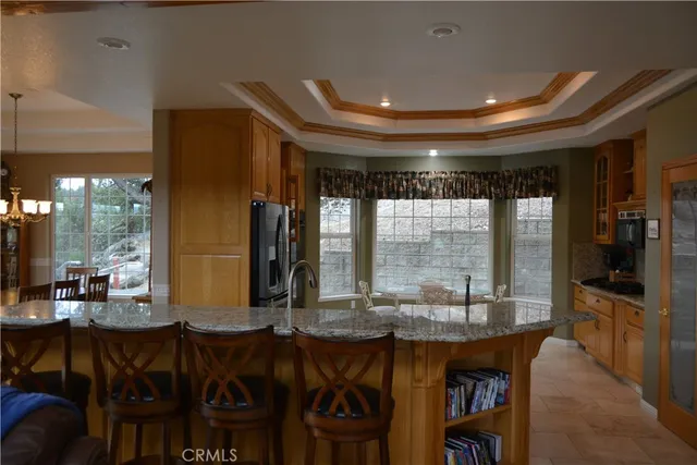 a room with lots of wooden furniture and large windows