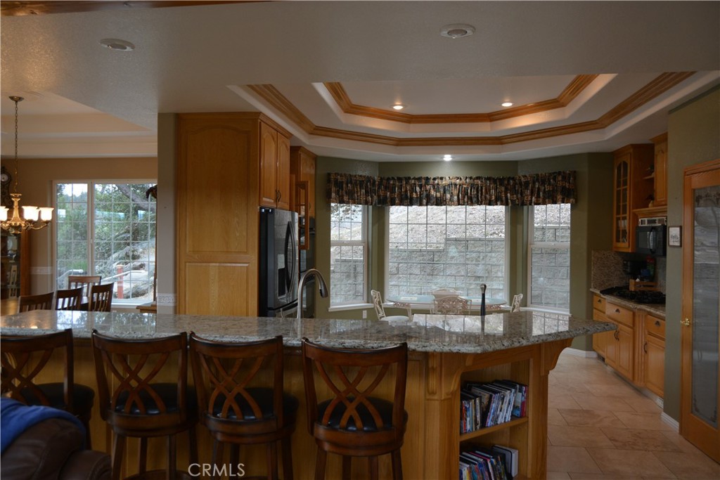 39818 Granite Ridge Lane Bass Lake, CA 93604 - Photo 5 of 29 a room with lots of wooden furniture and large windows