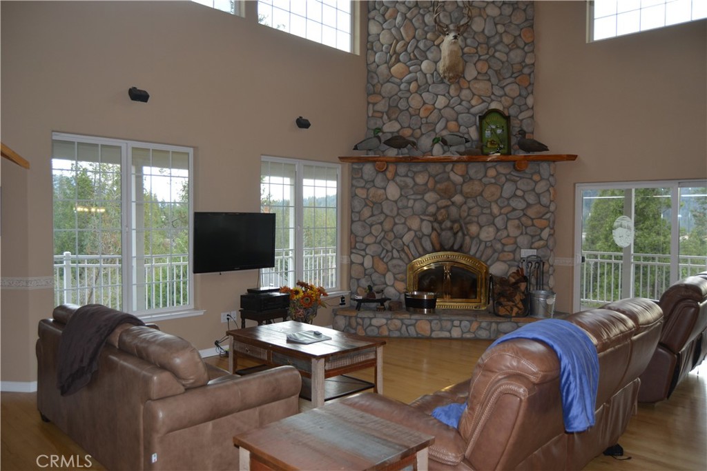 39818 Granite Ridge Lane Bass Lake, CA 93604 - Photo 8 of 29 a living room with furniture a fireplace and a flat screen tv