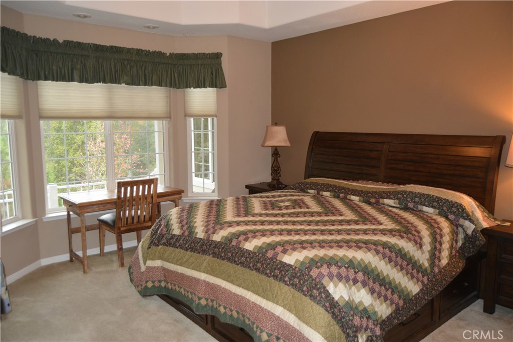 39818 Granite Ridge Lane Bass Lake, CA 93604 - Photo 10 of 29 a bedroom with a bed and a large window