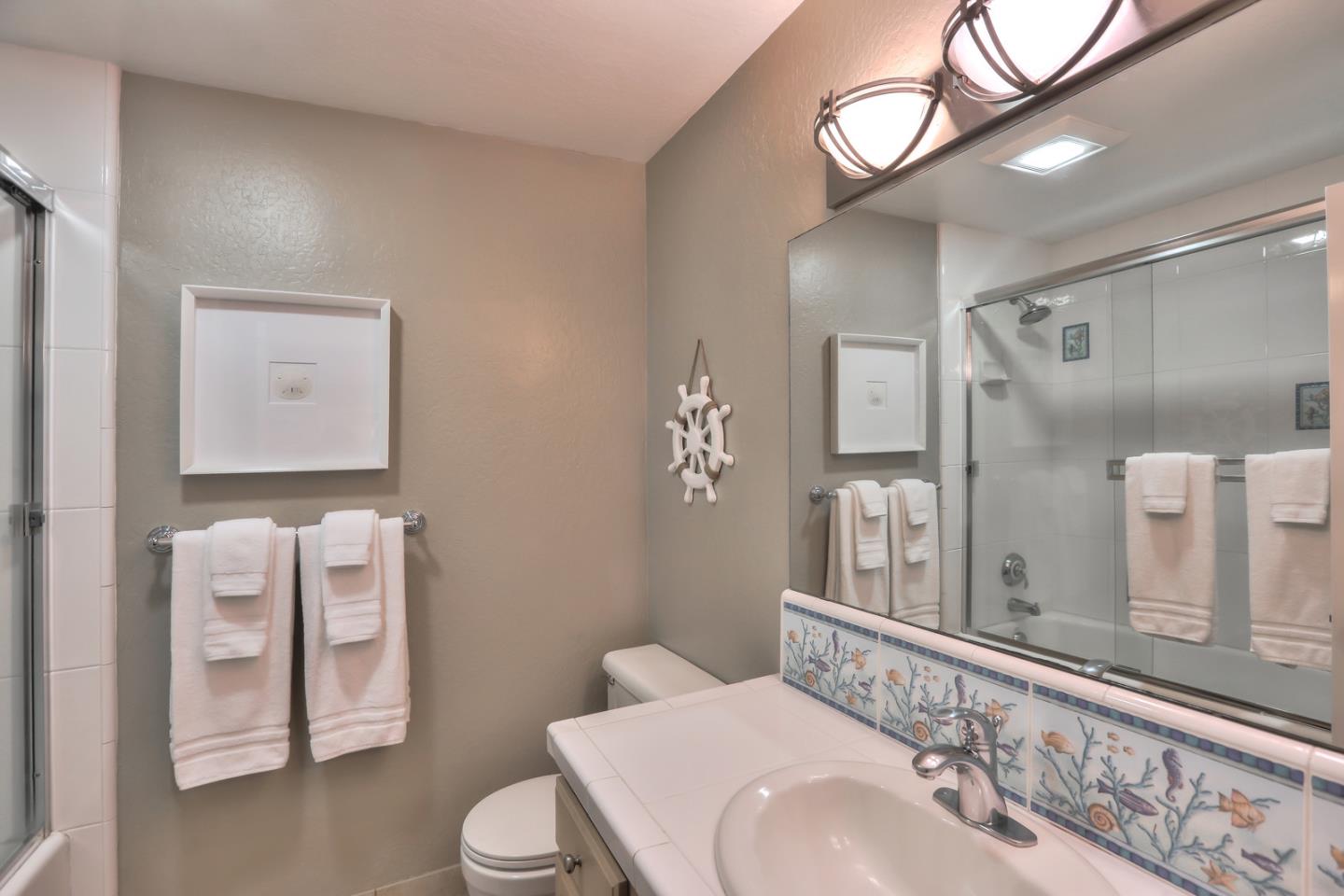 101 Shell Road, Unit 285 Watsonville, CA 95076 - Photo 12 of 27 a bathroom with a toilet a sink and mirror